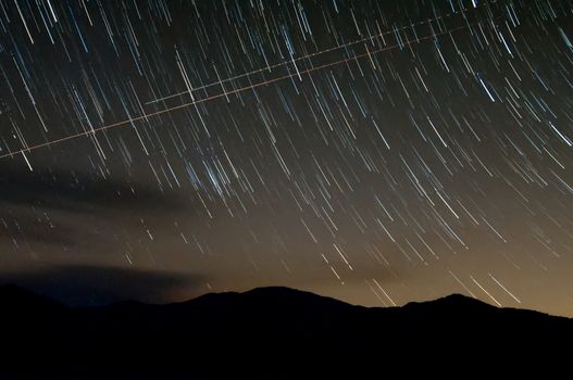 starry night with star trails over lake santeetlah and great smoky mountains