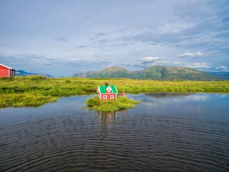 Aerial view of miniature norwegian house on lake