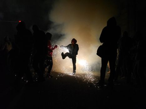 SPAIN, Barcelona; Correfoc, or Firerun, is a traditional Catalan festival held in Barcelona on September 20, 2015, in which groups of people dressed as devils light fireworks. 	The fireworks are directed towards the crowds, and spectators can join in and try to get as close as possible to the fireworks without getting burned. 