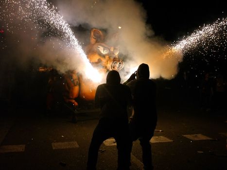 SPAIN, Barcelona; Correfoc, or Firerun, is a traditional Catalan festival held in Barcelona on September 20, 2015, in which groups of people dressed as devils light fireworks. 	The fireworks are directed towards the crowds, and spectators can join in and try to get as close as possible to the fireworks without getting burned. 