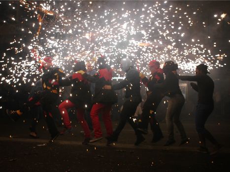 SPAIN, Barcelona; Correfoc, or Firerun, is a traditional Catalan festival held in Barcelona on September 20, 2015, in which groups of people dressed as devils light fireworks. 	The fireworks are directed towards the crowds, and spectators can join in and try to get as close as possible to the fireworks without getting burned. 