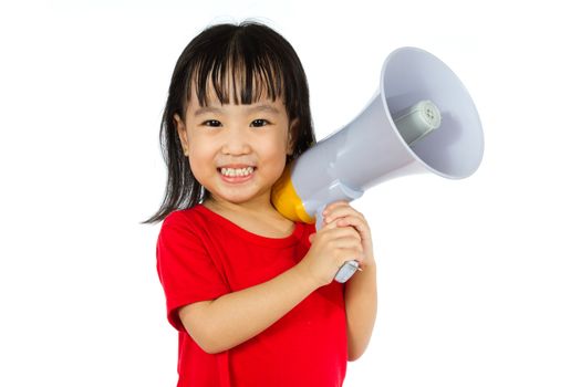 Portrait of a young little Chinese girl holding a megaphone in isolated white background.