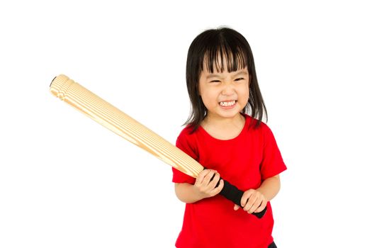 Portrait of a young little Chinese girl holding baseball bat with angry expression in white isolated background.
