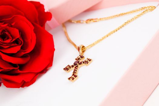 Golden Cross with garnets in packaged