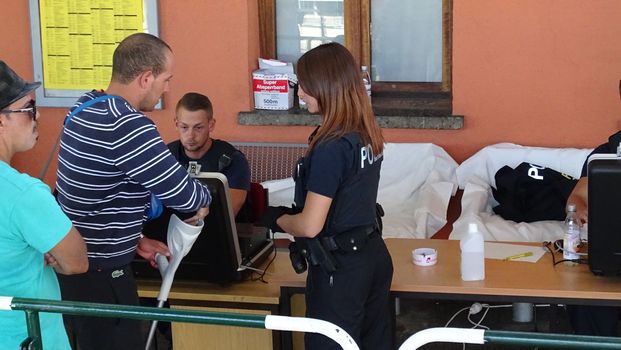 GERMANY, Freilassing: Refugees being stopped by police as they enter Germany from Austria at Freilassing train station, on September 21, 2015. 	The station has become a huge processing camp for migrants heading to Germany, following strict border controls being introduced. German police are now boarding trains from Austria and checking the documents of travellers. 