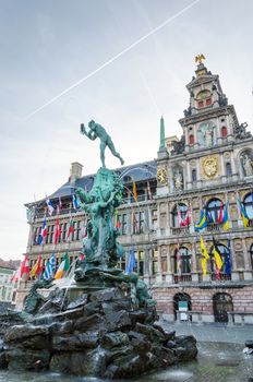 The Grand Place with the Statue of Brabo, throwing the giant's hand into the Scheldt River and City Hall of Antwerp, Belgium