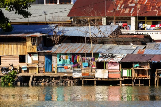 poor houses with sheet tin by the river, Kota Manado, North Sulawesi, Indonesia