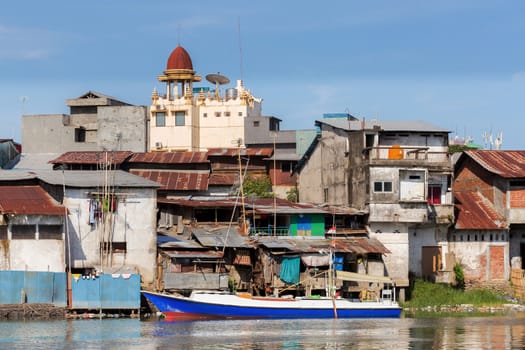 poor houses with sheet tin by the river, Kota Manado, North Sulawesi, Indonesia
