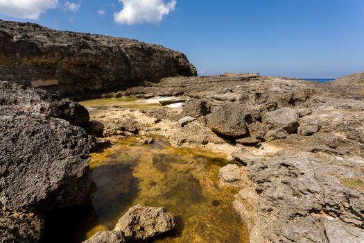 rock formation on dream coastline at Bali, near Manta Point famous Diving place, Nusa Penida with blue sky