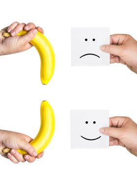 concept of potency, the concept of penis,  two men's hands holding smiley and sad  faces,  two hands hold the big bananas up and down, like the man penis, short, small, medium, average, long size