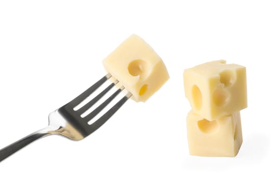  piece of cheese on iron fork and two slices of  diced cheese on  white background isolated