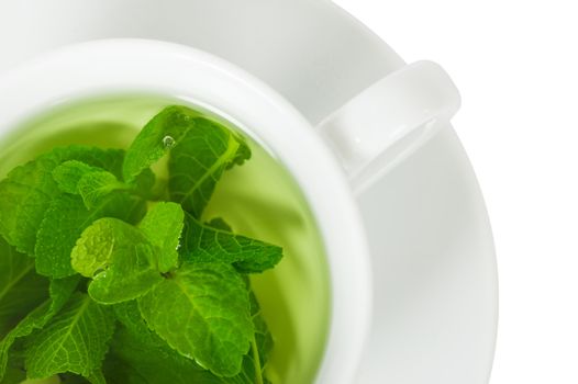 Mint tea with fresh mint in a white cup, top view, closeup, isolated on white