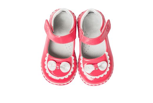 Pink baby girl summer sandals with white bows isolated on a white background,  closeup, top view,