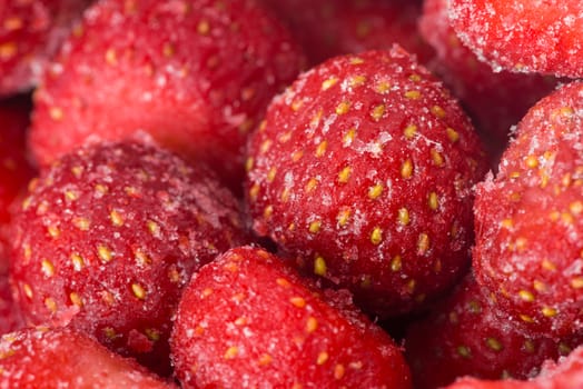 sweet frozen strawberries as a background, closeup