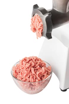 Mincer machine with fresh chopped meat and pork mince in a transparent glass bowl isolated on white background