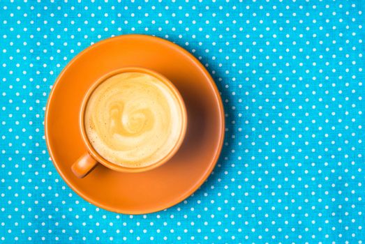 ceramic cup with coffee  espresso on a bright blue background, top view