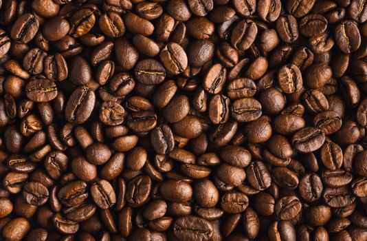 roasted coffee beans as a background, closeup, top view
