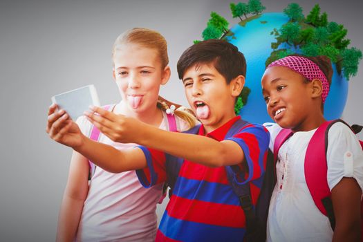 School kids taking selfie in school corridor against globe in front of statistic