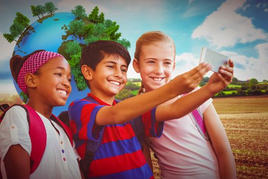 Happy kids taking selfie in school corridor against blue sky over fields