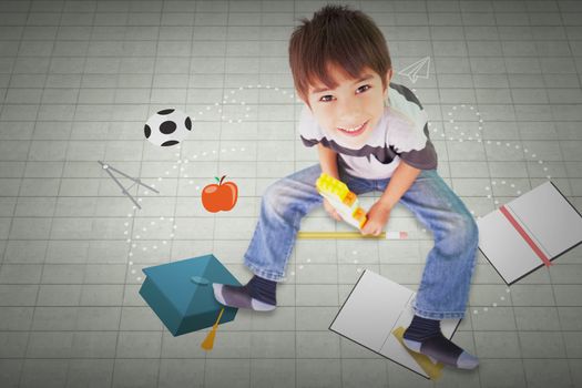 Cute boy sitting with building blocks against textured background