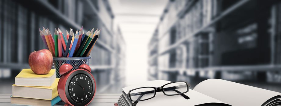 School supplies on desk against close up of a bookshelf