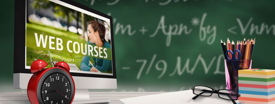 Computer screen against green chalkboard