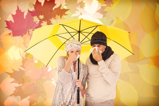 Couple sneezing in tissue while standing under umbrella against autumnal leaf pattern
