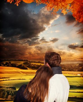 Close up rear view of romantic couple against country scene