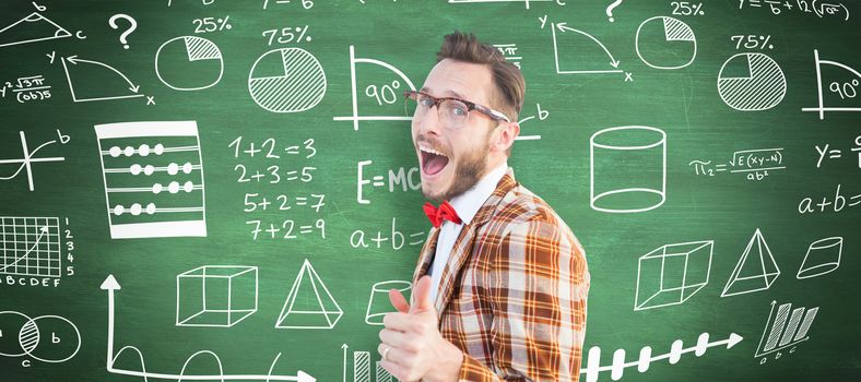 Geeky hipster pointing at camera against green chalkboard