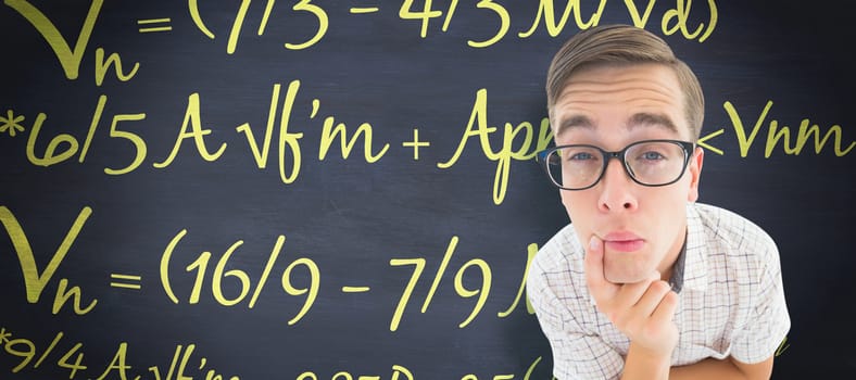 Geeky hipster thinking with hand on chin against blackboard