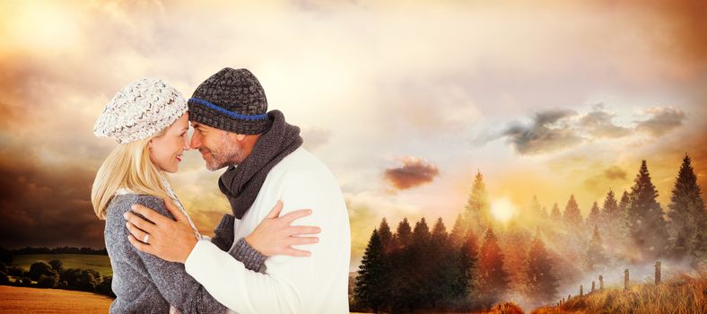 Smiling cute couple romancing over white background against country scene