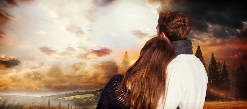 Close up rear view of romantic couple against country scene