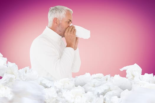 Sick man in winter fashion sneezing against pink vignette