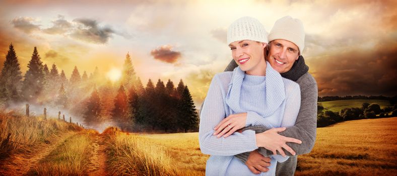 Casual couple in warm clothing against country scene