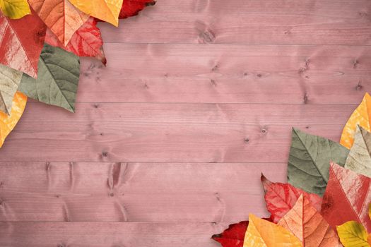 Autumn leaves pattern against bleached wooden planks background