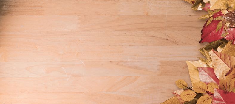 Autumn leaves pattern against bleached wooden planks background