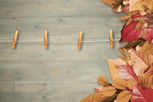 Autumn leaves pattern against bleached wooden planks background