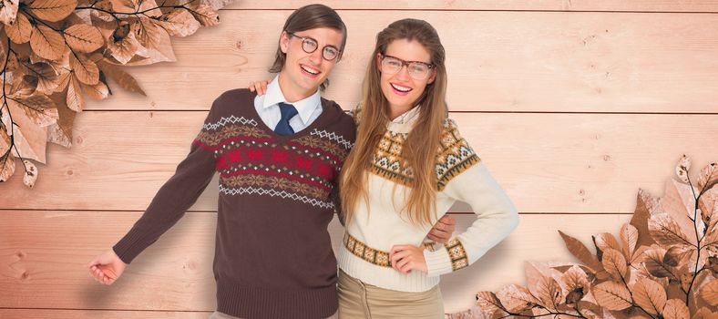 Happy geeky hipster couple embracing against overhead of wooden planks