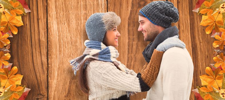 Young winter couple against wooden table