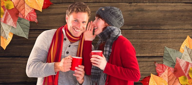 Couple both having warm drinks against overhead of wooden planks
