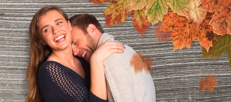 Close up of happy young couple against digitally generated grey wooden plank