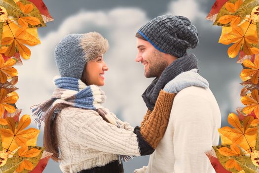 Young winter couple against cloudy sky