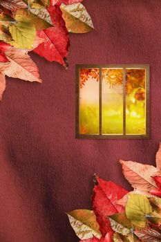 Digital image of glass window against autumn leaves pattern