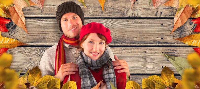 Couple smiling at the camera against wooden planks background