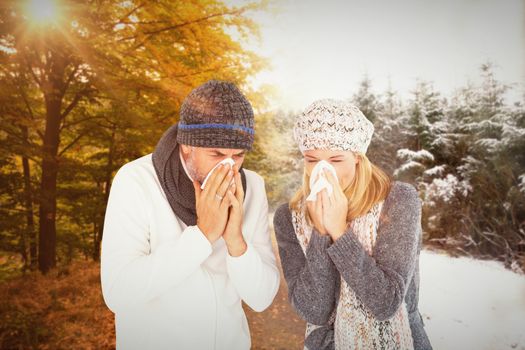 Couple sneezing in tissue against scenic shot of narrow road along forest