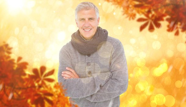Casual man in warm clothing against yellow abstract light spot design