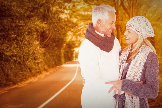 Cute happy couple romancing against country road