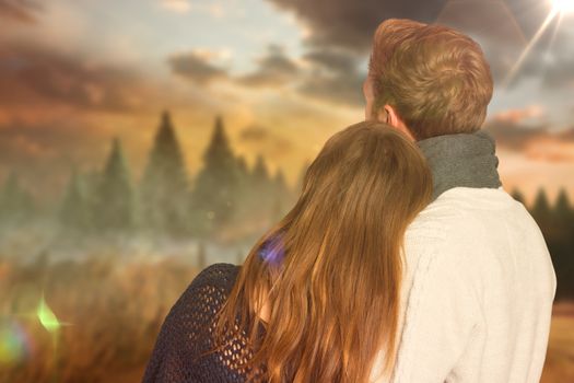 Close up rear view of romantic couple against country scene