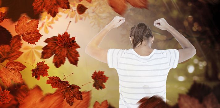 Depressed woman with hands raised against autumn scene