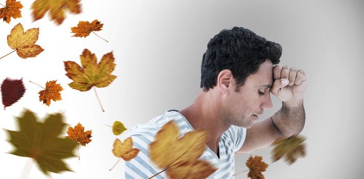 Upset man leaning on white background against autumn leaves